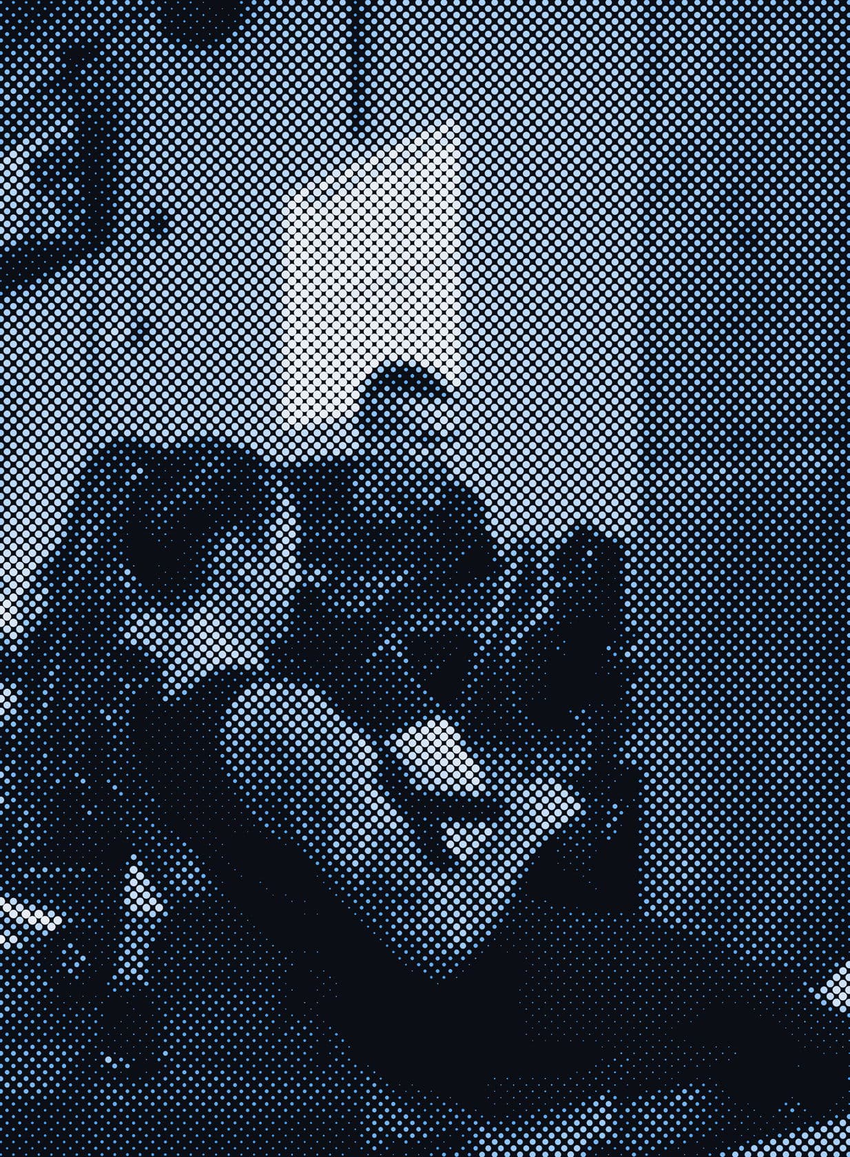 A coach guiding an athlete through a lift in the gym.
